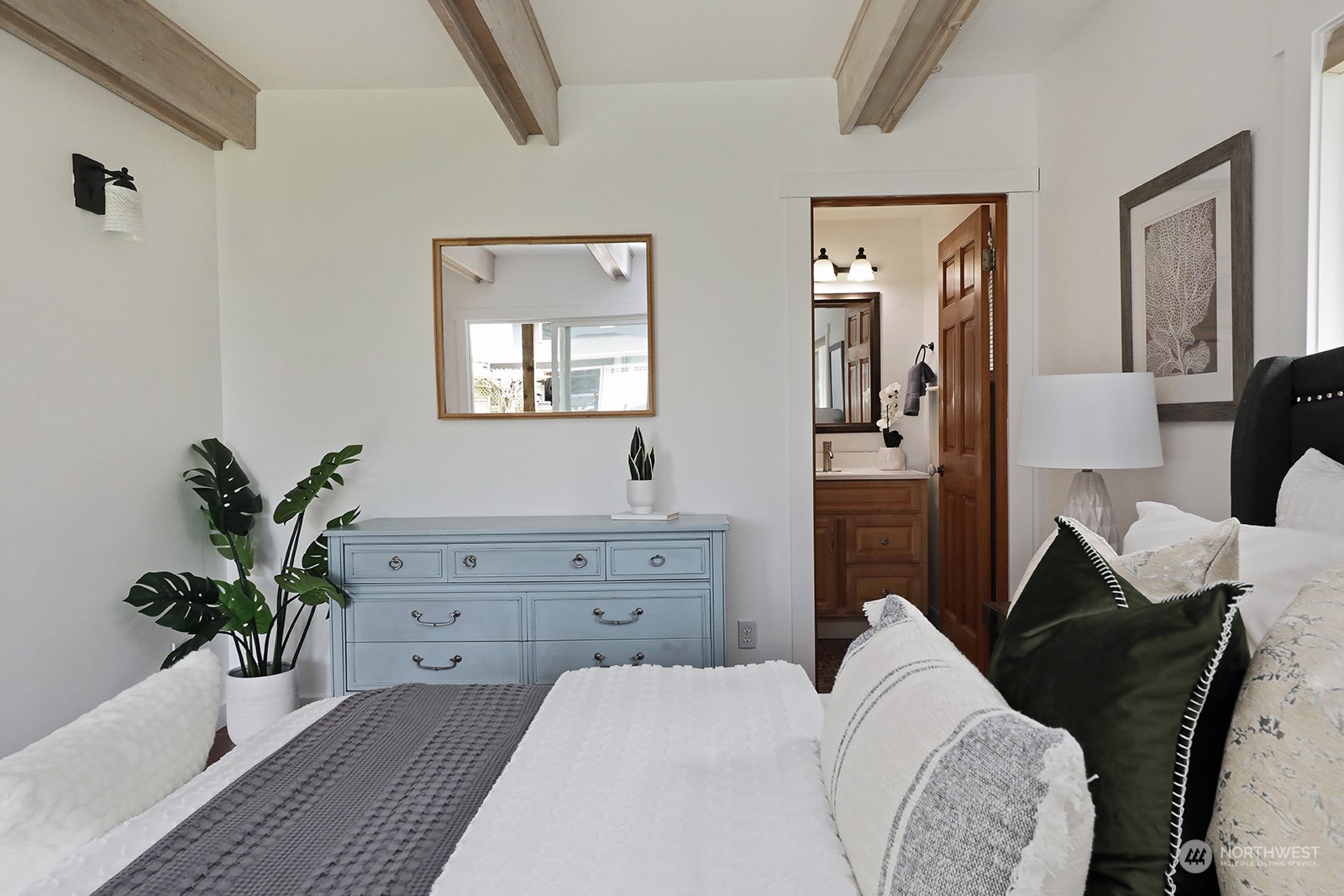 5880 Mutiny Bay Road Freeland, WA 98249 - Photo 24 of 40 a bedroom with a bed and a potted plant