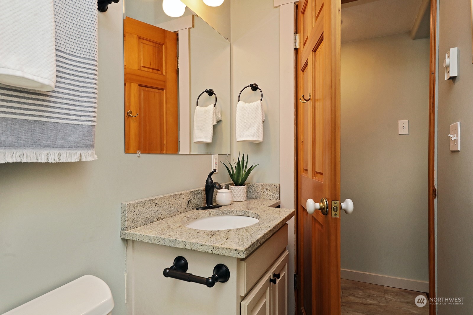 5880 Mutiny Bay Road Freeland, WA 98249 - Photo 27 of 40 a bathroom with a granite countertop sink and a mirror