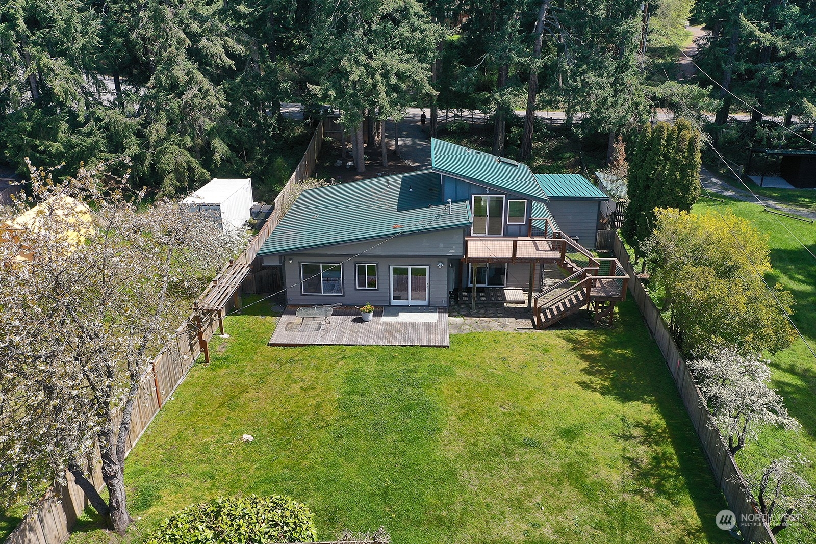 5880 Mutiny Bay Road Freeland, WA 98249 - Photo 5 of 40 a front view of house with a garden and swimming pool
