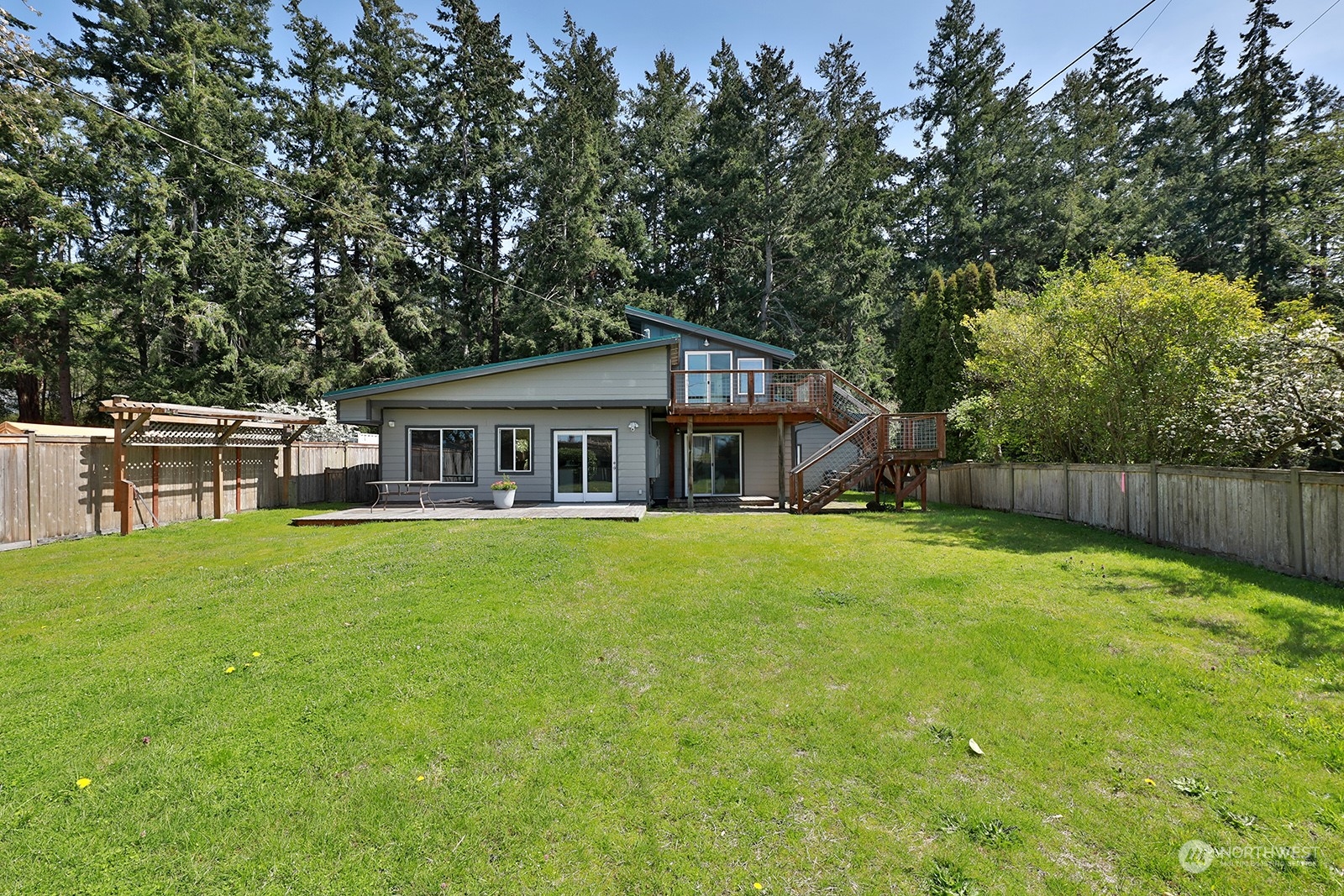5880 Mutiny Bay Road Freeland, WA 98249 - Photo 6 of 40 a front view of house with yard and seating area