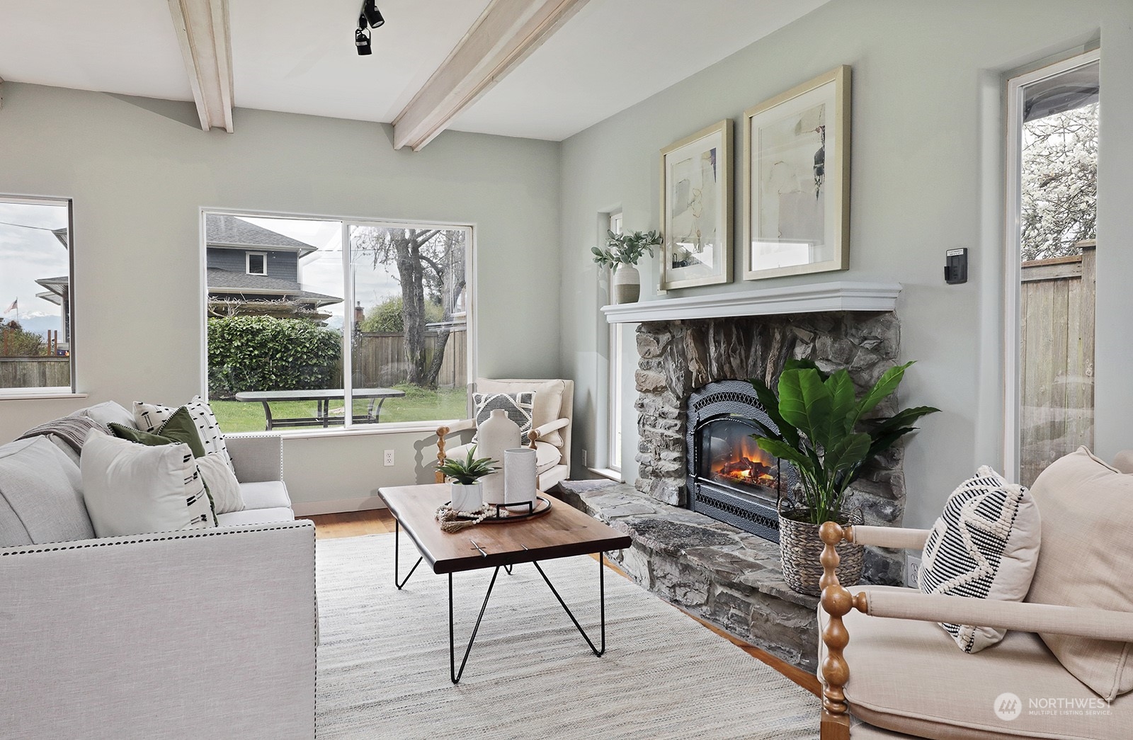 5880 Mutiny Bay Road Freeland, WA 98249 - Photo 9 of 40 a living room with furniture a fireplace and a potted plant