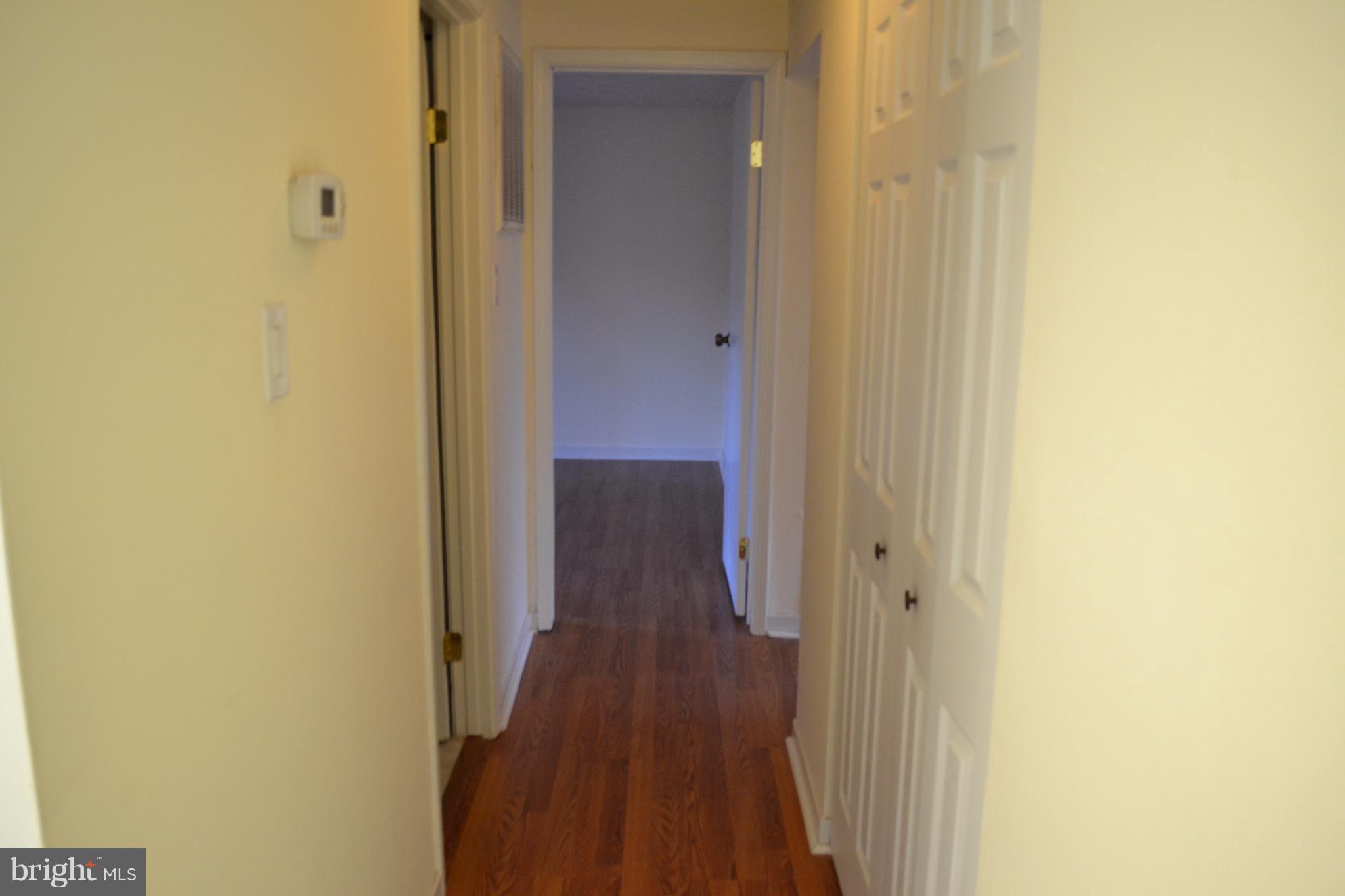 12900 Rousby Hall Road Lusby, MD 20657 - Photo 3 of 8 a view of a hallway with wooden floor