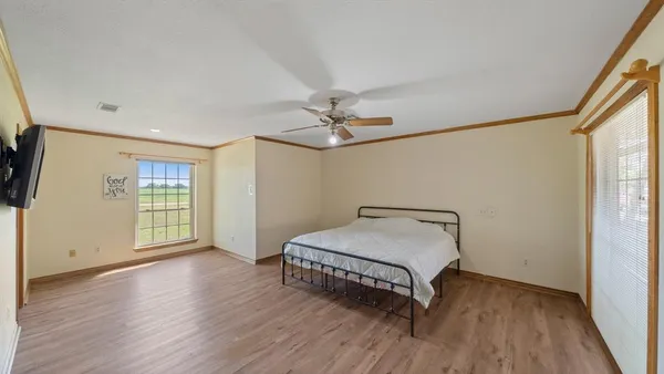 a room with a bed and wooden floor