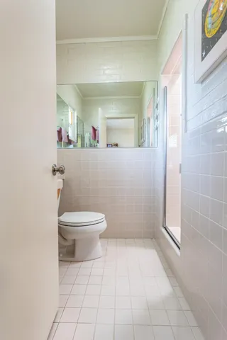 a bathroom with a toilet a sink and a window