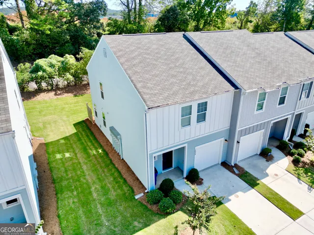an aerial view of a house with swimming pool garden and patio