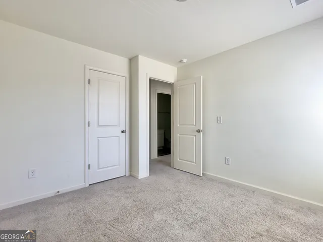 a view of an empty room and closet