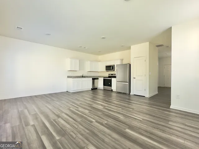 a view of kitchen and wooden floor