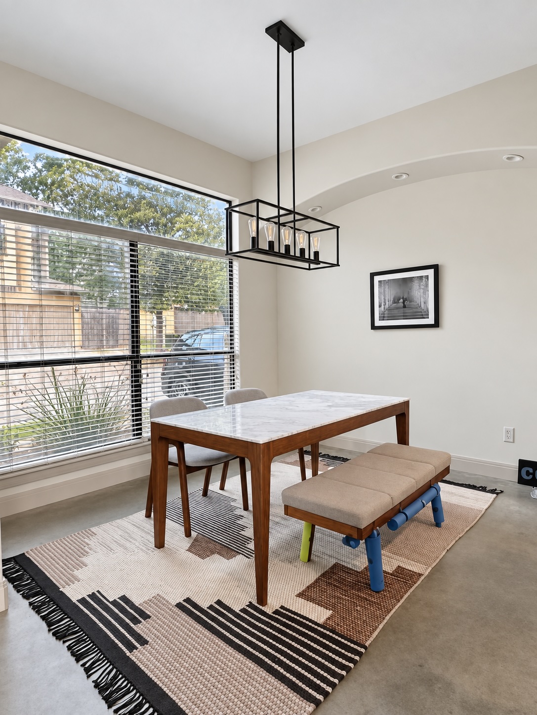 2316 Thornton Road, Unit B Austin, TX 78704 - Photo 9 of 25 Polished concrete floors and a modern linear chandelier anchor this versatile dining space.