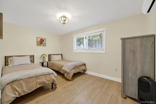 a bedroom with two beds and a desk
