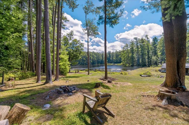 a view of backyard with swimming pool and sitting area