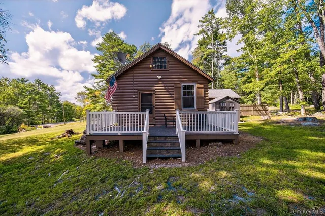 a view of a house with a yard and furniture