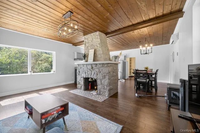 a living room with furniture a fireplace and wooden floor