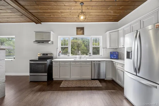 a kitchen with a refrigerator and a sink