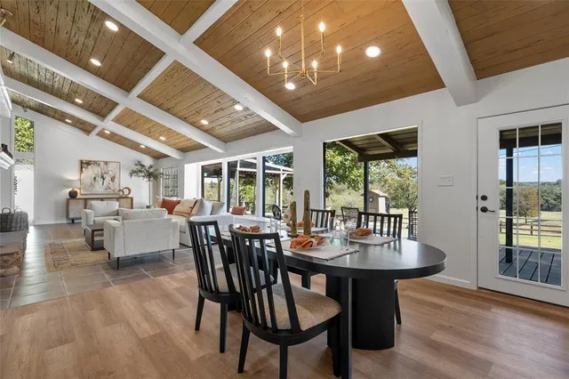 a dining room with furniture window and wooden floor