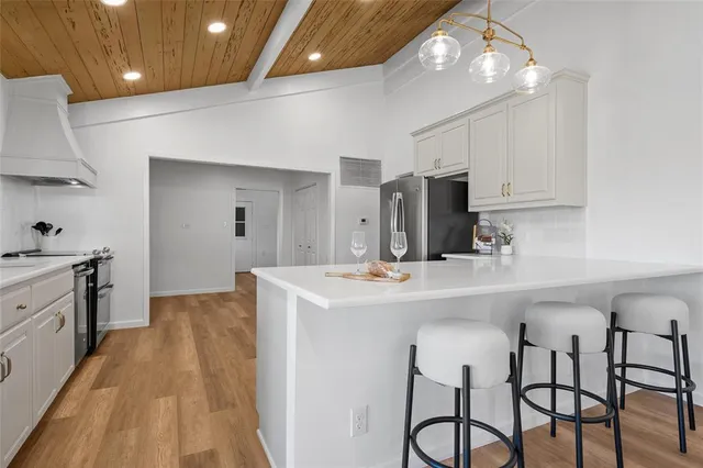 a kitchen with stainless steel appliances a sink stove and refrigerator