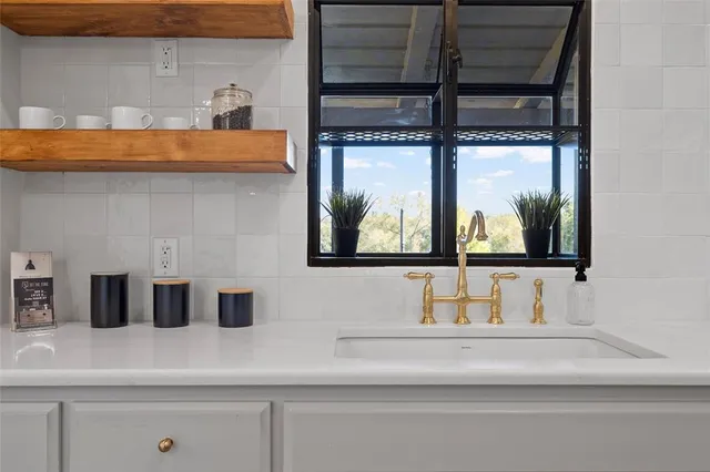 a bathroom with a sink and a large mirror