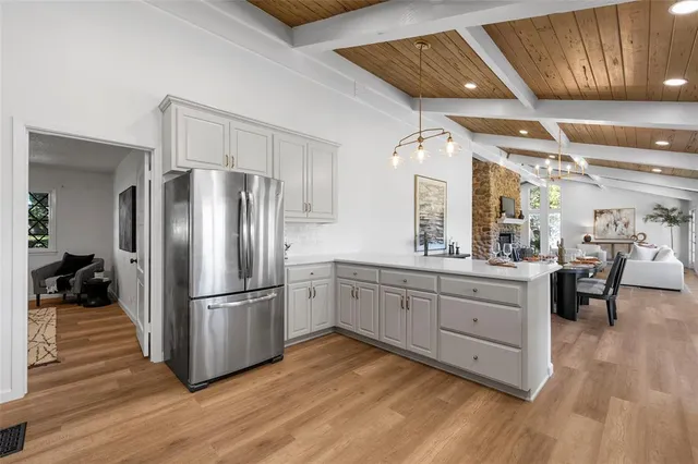 a kitchen with cabinets and stainless steel appliances