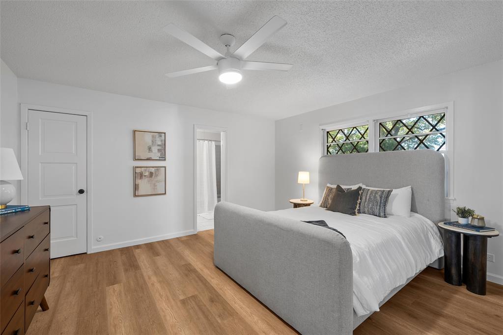 925 Church Road McGregor, TX 76657 - Photo 24 of 40 a bedroom with a large bed and a chandelier