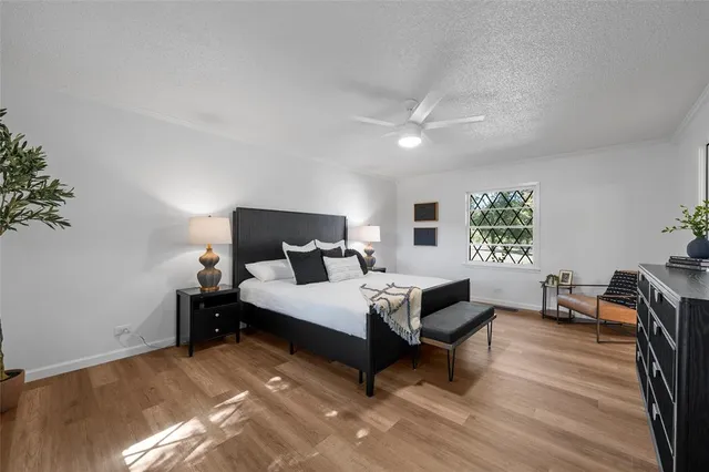 a spacious bedroom with a bed and a table in it