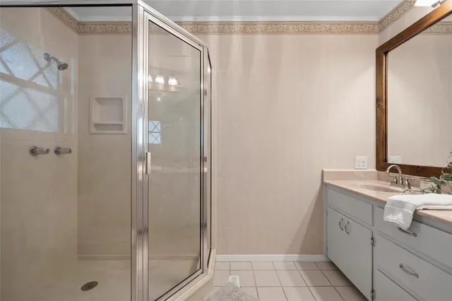 a bathroom with a granite countertop sink mirror and shower