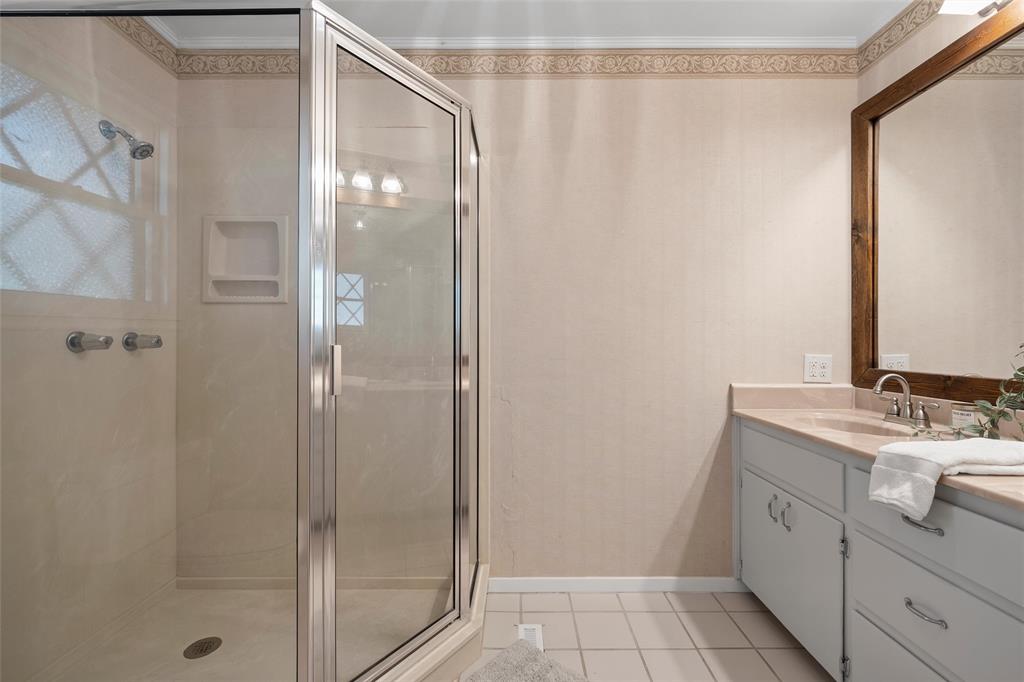 925 Church Road McGregor, TX 76657 - Photo 28 of 40 a bathroom with a granite countertop sink mirror and shower