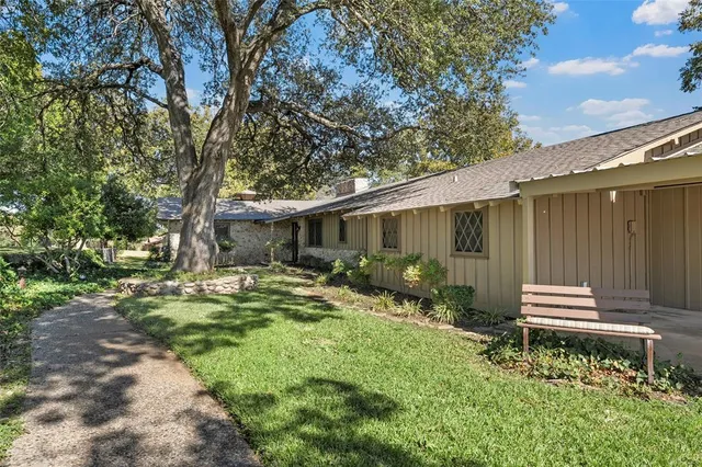a backyard of a house with yard and outdoor seating