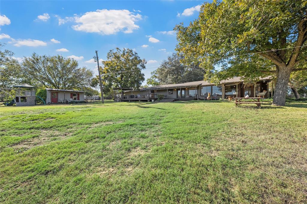 925 Church Road McGregor, TX 76657 - Photo 33 of 40 a view of a house with a yard and sitting area