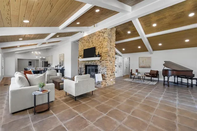 a living room with furniture a flat screen tv and a fireplace