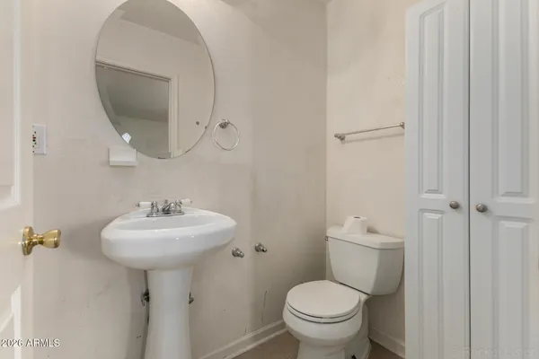 a bathroom with a sink a toilet and mirror