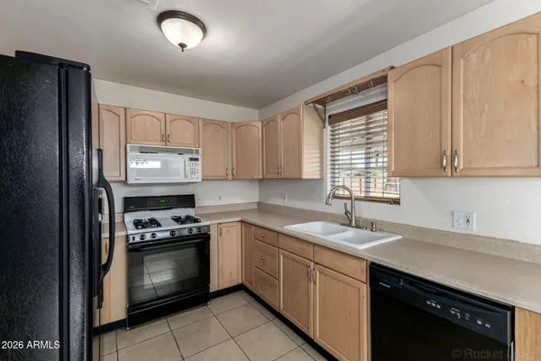 a kitchen with a sink stove and refrigerator