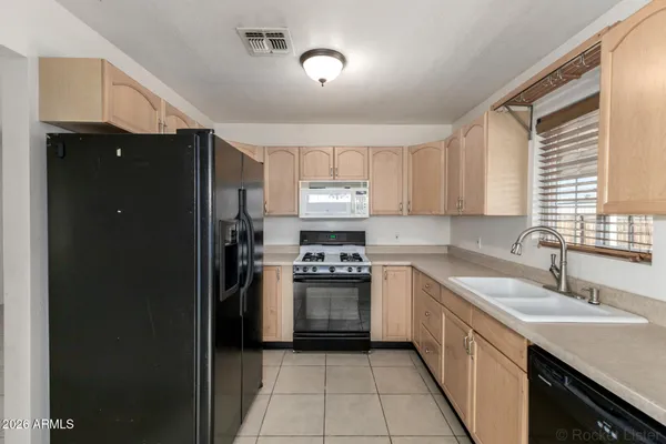 a kitchen with a sink stove and refrigerator