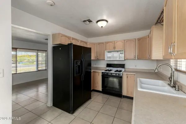 a kitchen with a refrigerator and a sink