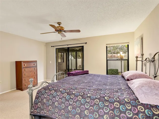 a bedroom with a bed and dresser with mirror