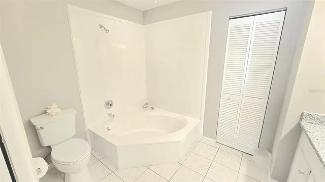 a white toilet sitting next to a bathroom sink