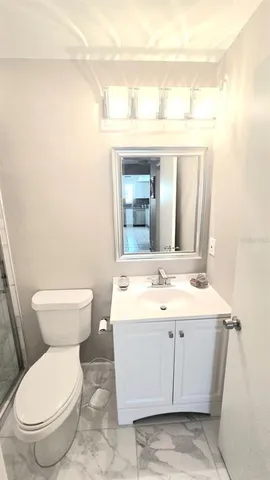 a bathroom with a sink a toilet and mirror