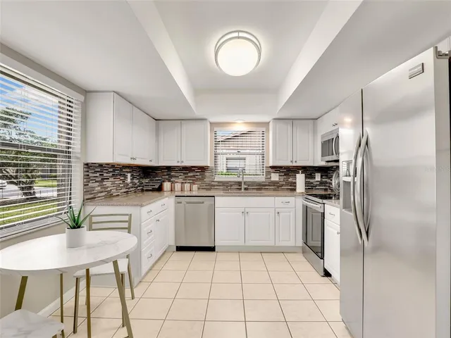 a kitchen with a refrigerator a sink dishwasher and a stove