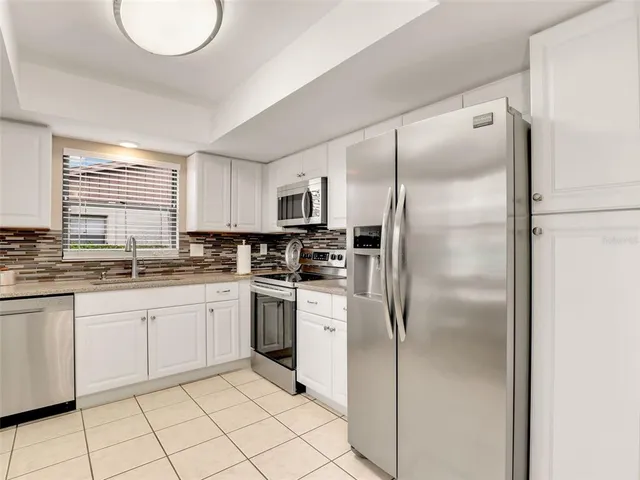 a kitchen with granite countertop cabinets and stainless steel appliances
