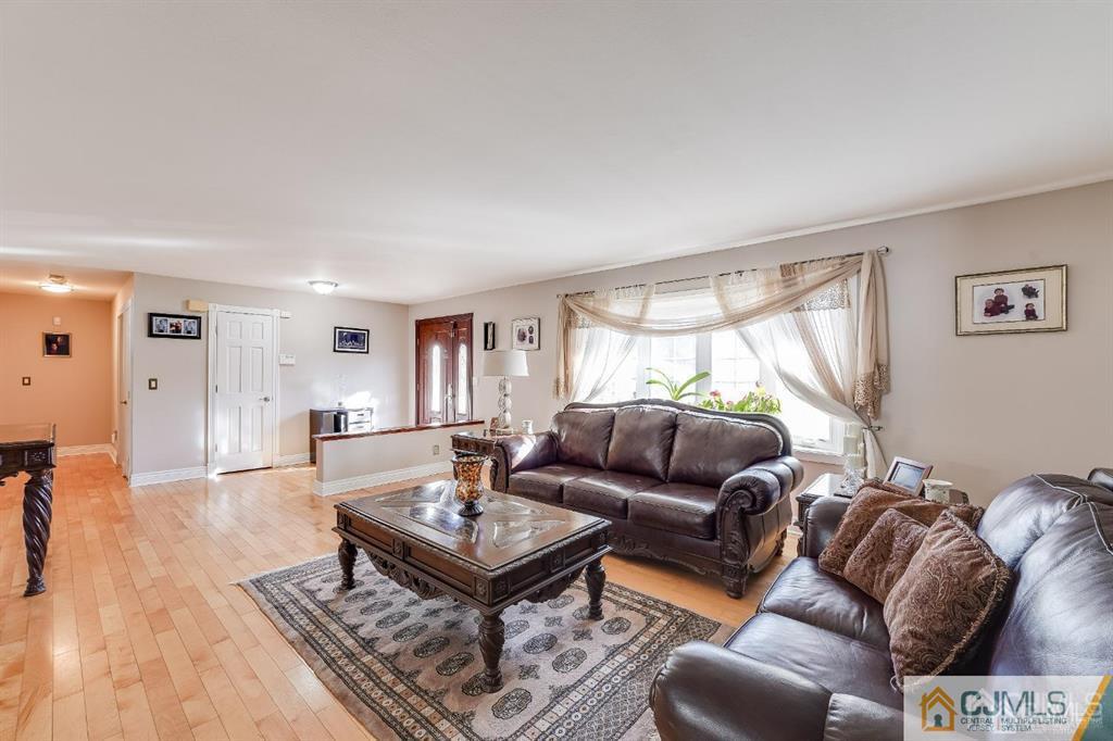 5 Starkin Road East Brunswick, NJ 08850 - Photo 1 of 34 a living room with furniture and a table