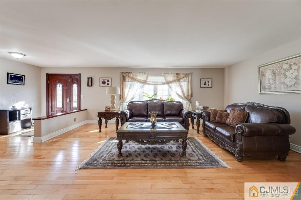 5 Starkin Road East Brunswick, NJ 08850 - Photo 12 of 34 a living room with furniture a rug and a large window