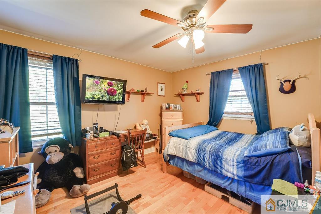 5 Starkin Road East Brunswick, NJ 08850 - Photo 16 of 34 a bedroom with a bed and a chandelier