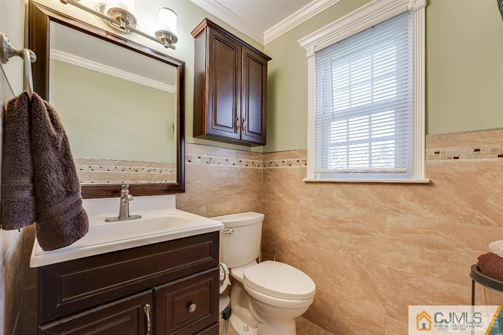 5 Starkin Road East Brunswick, NJ 08850 - Photo 18 of 34 a bathroom with a sink vanity mirror and toilet