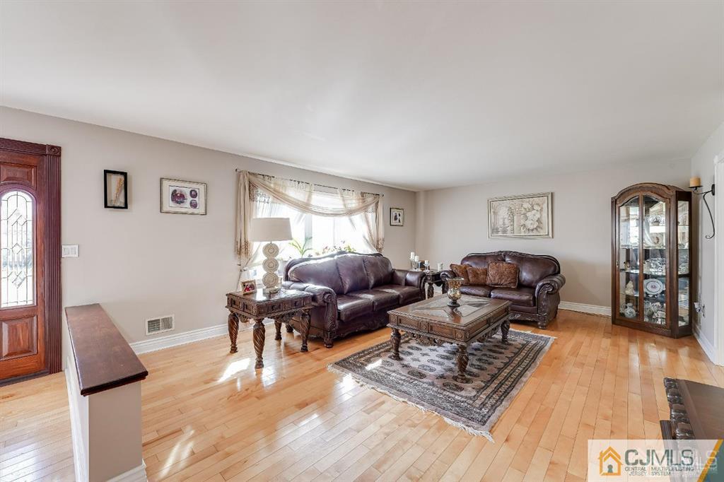 5 Starkin Road East Brunswick, NJ 08850 - Photo 3 of 34 a living room with furniture rug and window