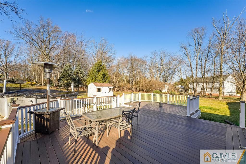 5 Starkin Road East Brunswick, NJ 08850 - Photo 33 of 34 a view of a patio with dining table and chairs with wooden floor and fence