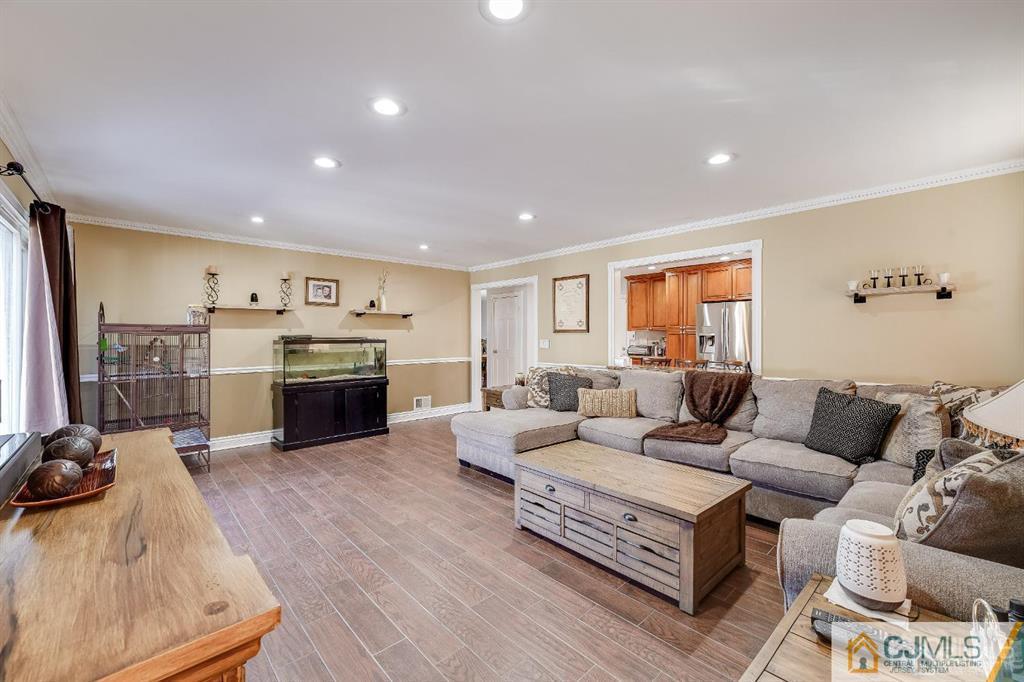 5 Starkin Road East Brunswick, NJ 08850 - Photo 9 of 34 a living room with furniture kitchen view and a fireplace