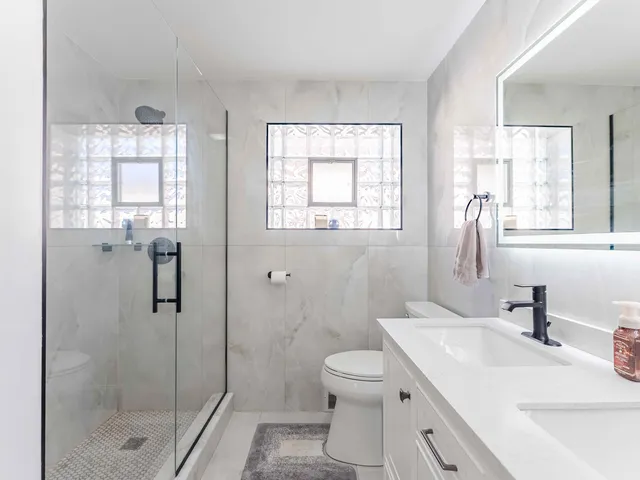 a bathroom with a sink toilet and shower