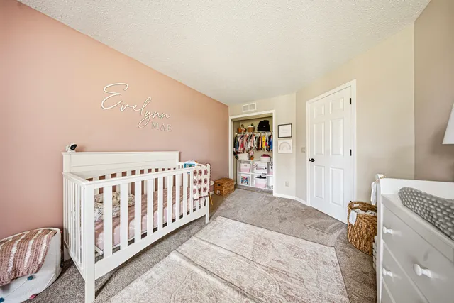 a view of a bedroom with wooden floor and furniture