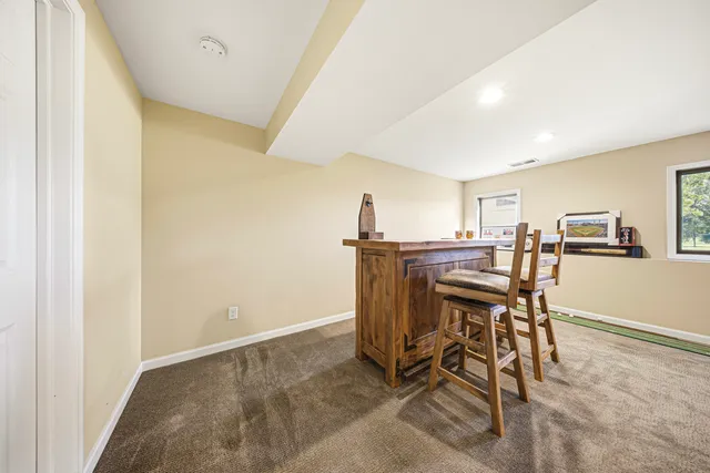 a view of a dining room with furniture and a rug