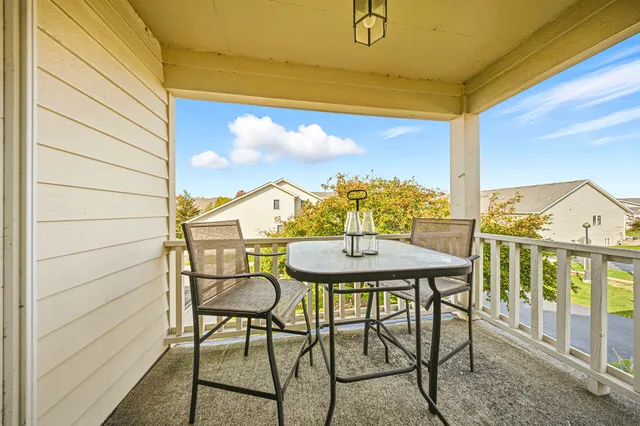a view of a balcony with table and chairs