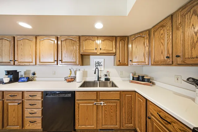 a kitchen with a sink cabinets and window