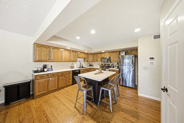 a kitchen with a sink a counter top space and stainless steel appliances